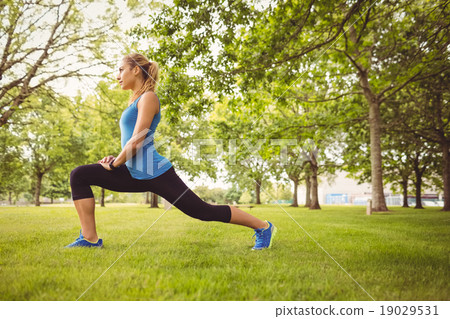 Woman doing stretching exercise in park Woman doing stretching exercise in park 19029531