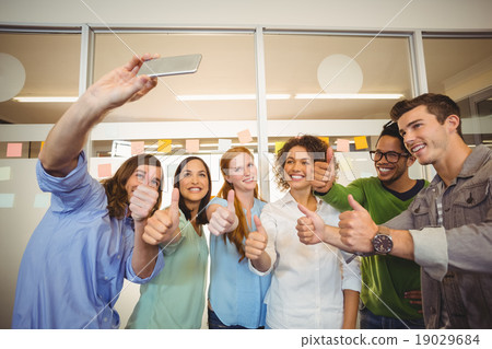 Business people taking selfie with thumbs up Business people taking selfie with thumbs up 19029684