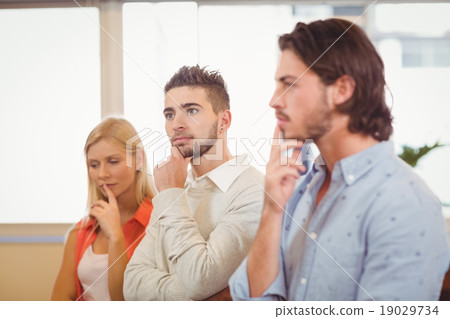 Thoughtful business people with hand on chin 19029734