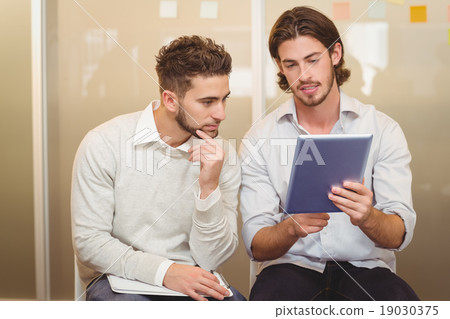 Businessman showing digital tablet Businessman showing digital tablet 19030375