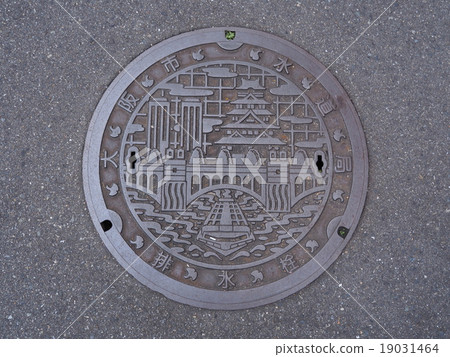 Manhole drain cover on the street at Osaka, Japan. Manhole drain cover on the street at Osaka, Japan. 19031464