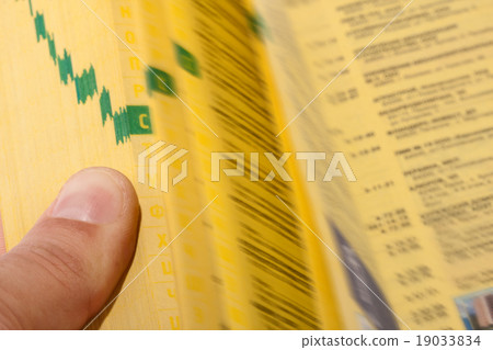 Hand searching the yellow pages Hand searching the yellow pages 19033834