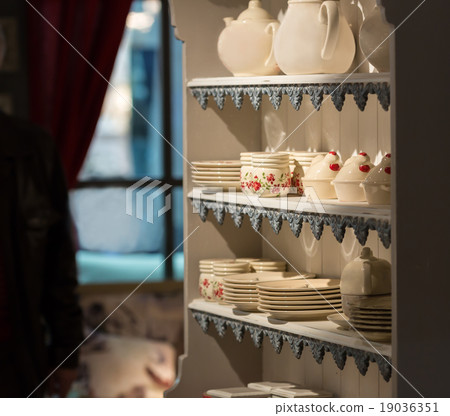 Set of dishes on the shelf 19036351