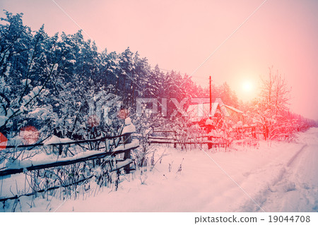 Sunrise over snowy village 19044708