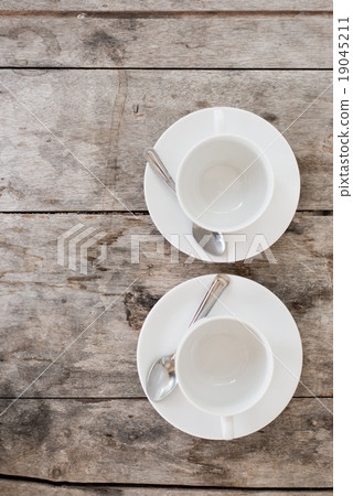 Two White cup on wood table Two White cup on wood table 19045211