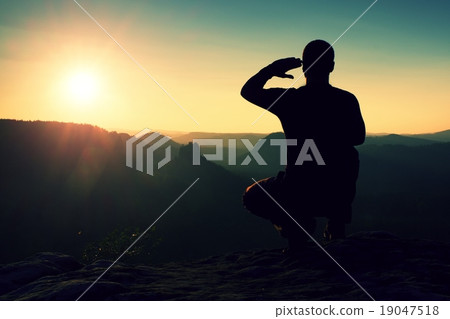 Alone sportsman in squatting position enjoy sunset 19047518