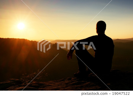Sportsmann hiker on mountain take a rest on rock 19047522