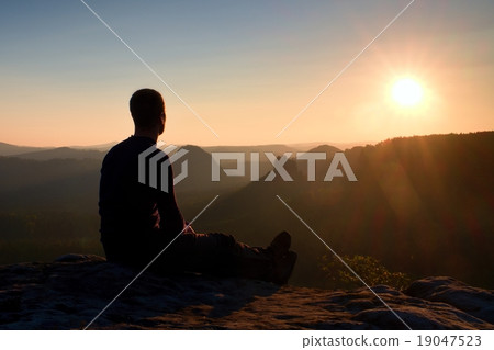 Tourist take a rest on rock and enjoying view Tourist take a rest on rock and enjoying view 19047523