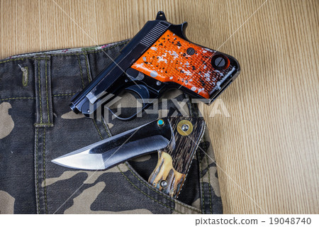 Gun on camouflage background. 19048740