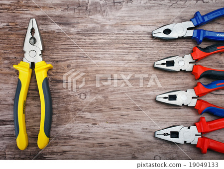 pliers on wooden background 19049133