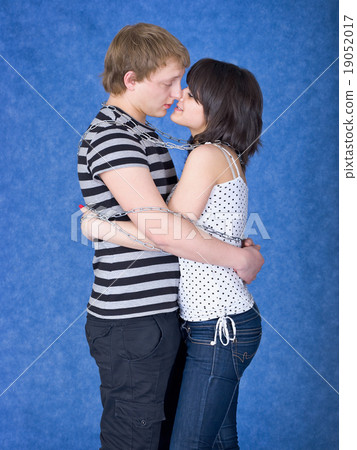 Loving couple chained by a chain Loving couple chained by a chain 19052017