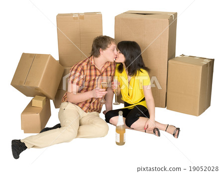 Girl and the guy drink champagne near boxes Girl and the guy drink champagne near boxes 19052028