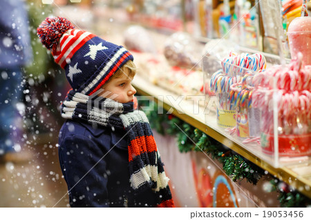 Little kid boy with candy cane stand on Christmas Little kid boy with candy cane stand on Christmas 19053456