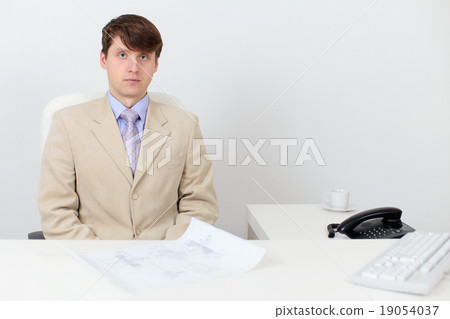 Serious man in a business suit at work in office Serious man in a business suit at work in office 19054037