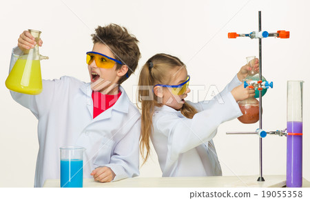 Two cute children at chemistry lesson making Two cute children at chemistry lesson making 19055358