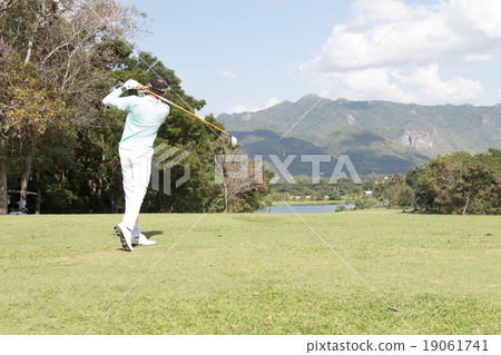 a man swinging golf on fairway a man swinging golf on fairway 19061741