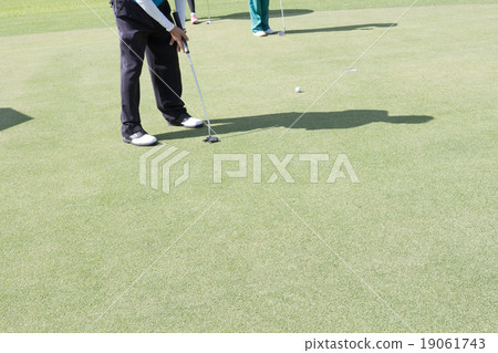 a man putting golf on fairway a man putting golf on fairway 19061743