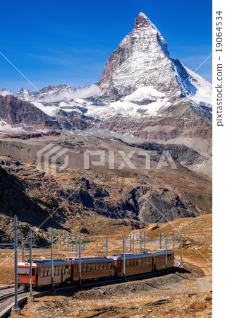 Matterhorn peak with a train in Swiss Alps 19064534