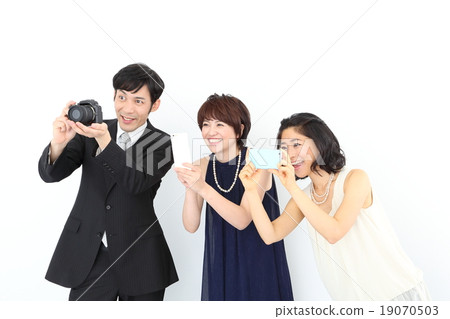 Guests turning the camera at the wedding party 19070503