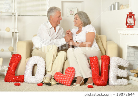 Elderly people sitting on couch 19072644
