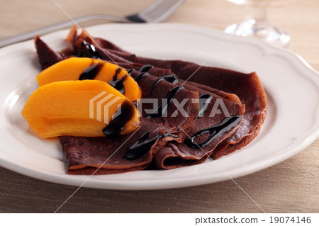 Chocolate crepes with persimmon 19074146