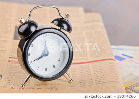 Close-up of clock, Euro banknotes and newspaper Close-up of clock, Euro banknotes and newspaper 19074260