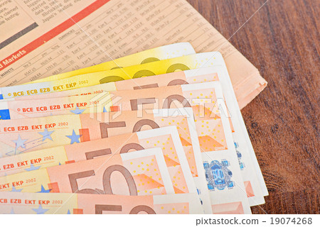 Close-up of Euro banknotes with newspaper Close-up of Euro banknotes with newspaper 19074268