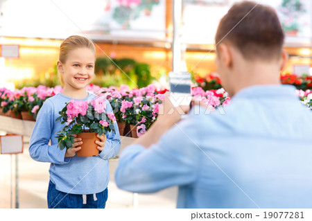 Little girl posing with flower. Little girl posing with flower. 19077281