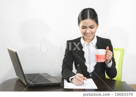 Attractive asian business women is drinking coffee Attractive asian business women is drinking coffee 19083379