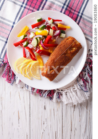 fried fish fillet with fresh vegetables and lemon 19083860