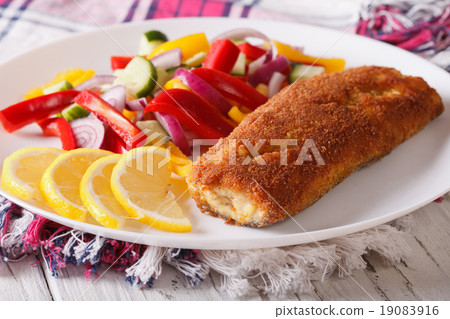breaded fried fish with fresh vegetable salad breaded fried fish with fresh vegetable salad 19083916