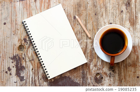 brown note book with coffee cup on grunge wood brown note book with coffee cup on grunge wood 19085235