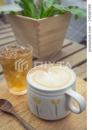 Cup of latte coffee with cold tea on wooden tray 19086566
