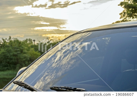 Car against sunset in background clear glass car Car against sunset in background clear glass car 19086607