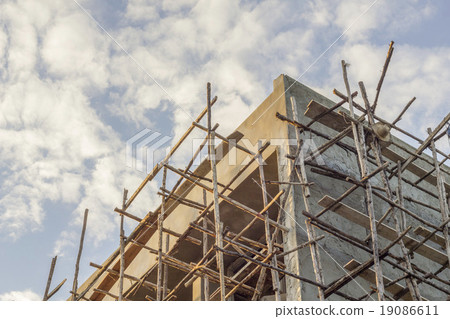 The Building contruction with a Wooden scaffold The Building contruction with a Wooden scaffold 19086611