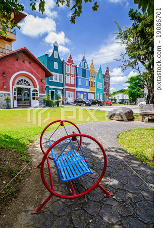 Old red iron swing in the garden. Old red iron swing in the garden. 19086701