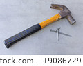 yellow hammer and nails on tile surface background 19086729