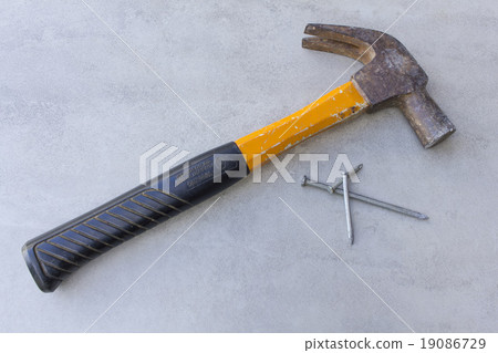 yellow hammer and nails on tile surface background yellow hammer and nails on tile surface background 19086729