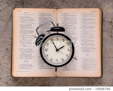 Retro alarm clock on holy bible on three o'clock. Retro alarm clock on holy bible on three o'clock. 19086760