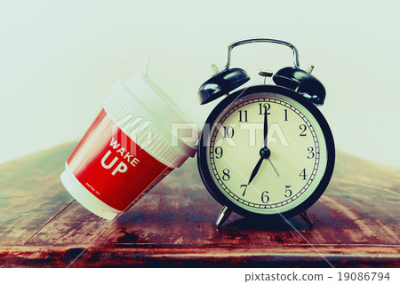 Vintage alarm clock and red coffee cup 19086794