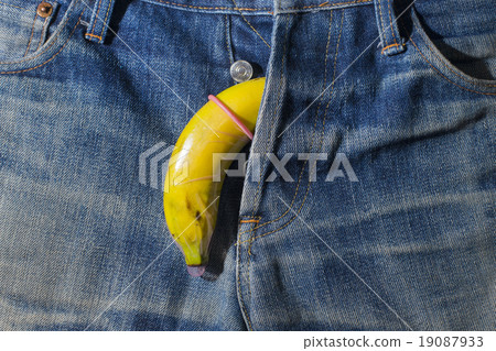 Banana condom on the jeans background Banana condom on the jeans background 19087933