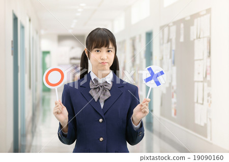 Posing school girls in uniform with standing ○ × sign at the school corridor Posing school girls in uniform with standing ○ × sign at the school corridor 19090160