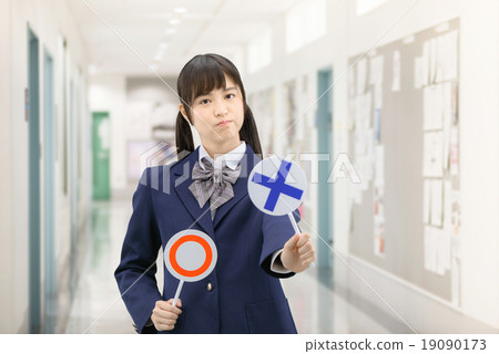 Posing school girls in uniform with standing ○ × sign at the school corridor Posing school girls in uniform with standing ○ × sign at the school corridor 19090173