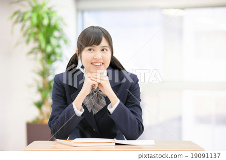 Girls high school girl posing in uniform wearing sitting at desk 19091137