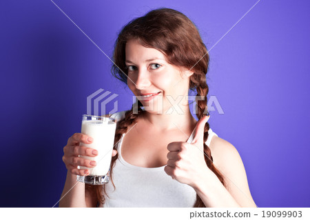 woman enjoying a glass of milk 19099903