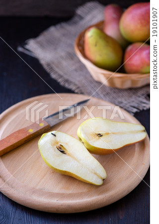 Juicy pears on a rustic wooden kitchen table Juicy pears on a rustic wooden kitchen table 19101907