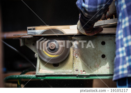 Old carpenter working with wood 19105217
