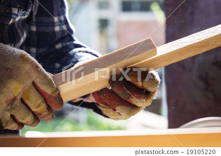 Carpenter working with wood, close up photo 19105220