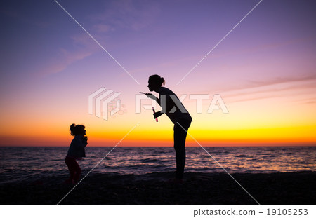 Silhouette of Mother and daughter playing  19105253