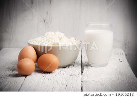 Fresh dairy products and eggs on rustic wood 19106218